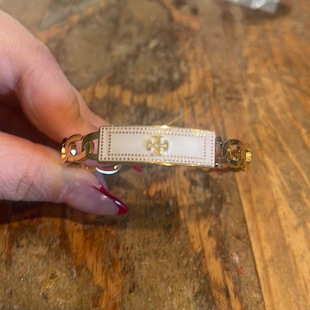 Designer style gold and white bangle. Stainless steel with gold plating